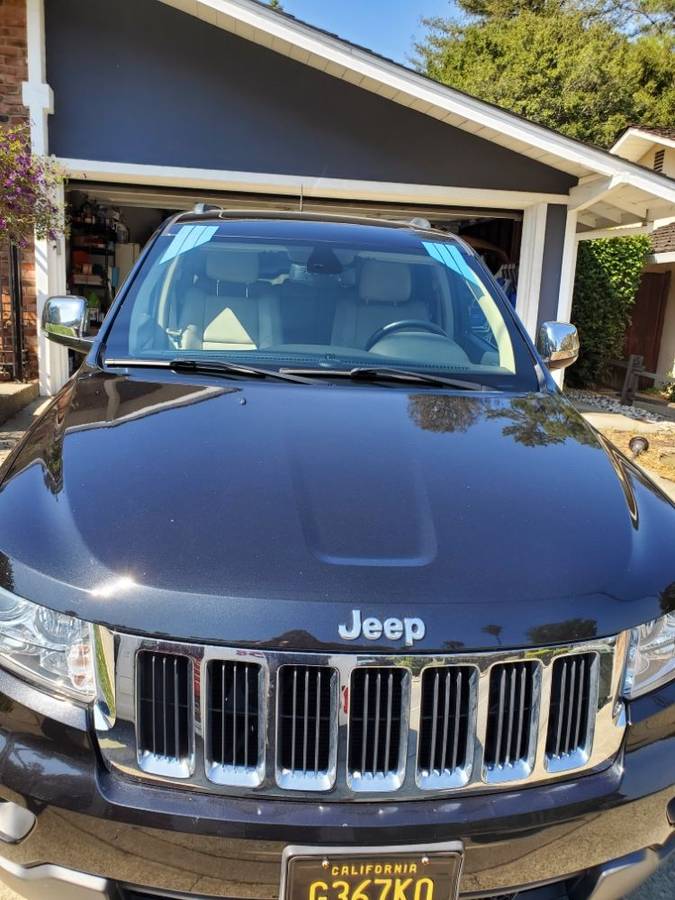 Jeep Grand Cherokee in a driveway after a windshield replacement